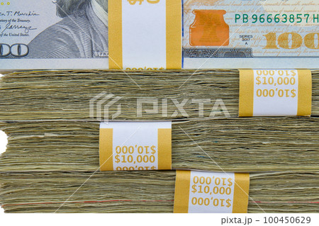 Close up of 4 straps of 100 dollar bills totaling ten thousand US dollars each stacked on top of each other, side view. High quality photo 100450629