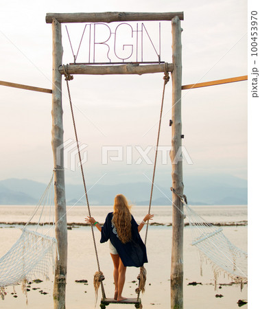 girl on a swing overlooking the sea girl on a swing overlooking the sea 100453970