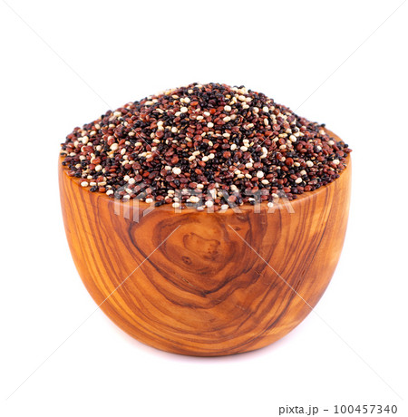 Quinoa seeds in wooden bowl, isolated on white background. Mix of white, red and black quinoa. Quinoa seeds in wooden bowl, isolated on white background. Mix of white, red and black quinoa. 100457340
