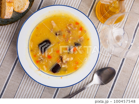 Hot pea soup with smoked meats and vegetables Hot pea soup with smoked meats and vegetables 100457548