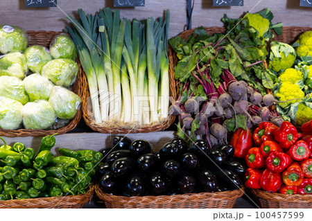 Different vegetables neatly arranged in baskets 100457599