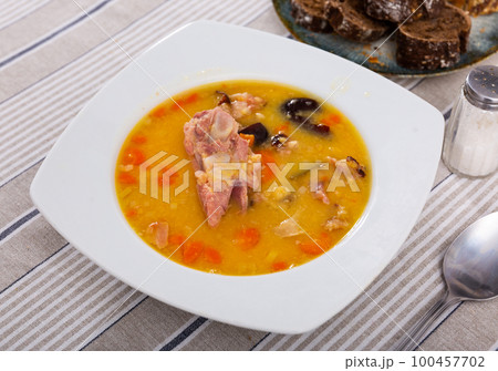 delicious pea soup with smoked meats 100457702