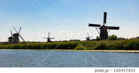 Windmills at Kinderdijk along riverside 100457852