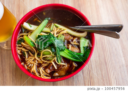 Beef soup with noodles 100457956