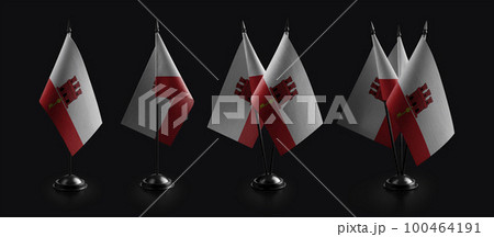 Small national flags of the Gibraltar on a black background 100464191