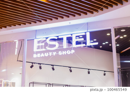 estel beauty shop neon light store sign close-up. entrance of perfumery and cosmetics shop. estel beauty shop neon light store sign close-up. entrance of perfumery and cosmetics shop. 100465549