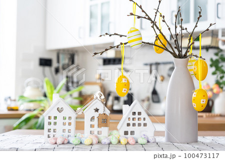 Key to house of cozy home with Easter decor with rabbit and eggs on table of kitchen. Building, design, project, moving to new house, mortgage, insurance, rent and purchase real estate Key to house of cozy home with Easter decor with rabbit and eggs on table of kitchen. Building, design, project, moving to new house, mortgage, insurance, rent and purchase real estate 100473117
