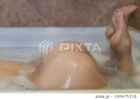 Female buttocks closeup in bath Female buttocks closeup in bath 100475319