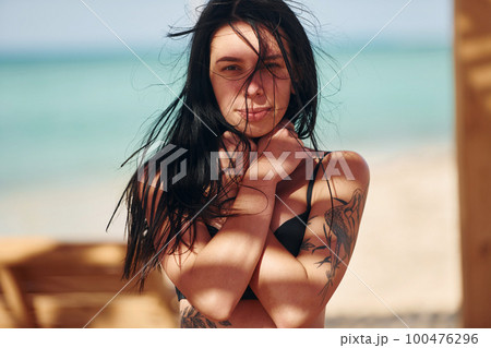 Beautiful young woman in bikini have vacation on the sea at sunny daytime Beautiful young woman in bikini have vacation on the sea at sunny daytime 100476296