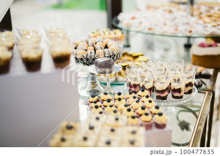 Delicious wedding reception candy bar dessert table 100477635