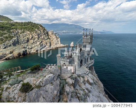Crimea Swallow's Nest Castle on the rock over the Black Sea. It is a tourist attraction of Crimea. Amazing aerial view of the Crimea coast with the castle above abyss on sunny day. 100477945