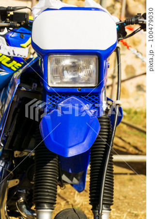 Blue cross motorcycle headlight at the front of the 100479030