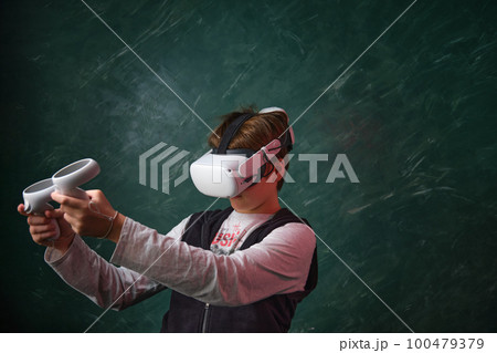 a boy playing with VR headset a boy playing with VR headset 100479379