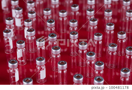 Bottles coronavirus vaccine, pandemic background 100481178