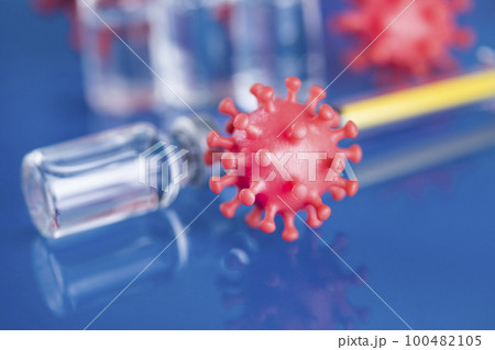 Close up medical syringe with a vaccine Close up medical syringe with a vaccine 100482105