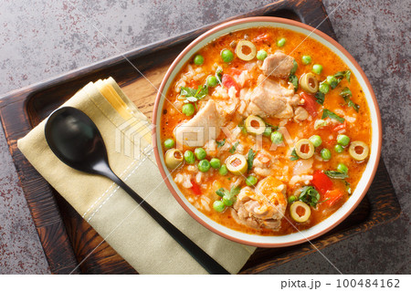 Asopao de Pollo this comforting Puerto Rican chicken and rice gumbo dish is loved throughout the Caribbean closeup on the bowl. Horizontal top view 100484162