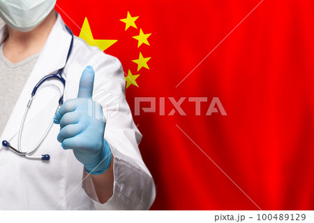 Chinese doctor's hand showing thumb up positive gesture on flag of China background 100489129