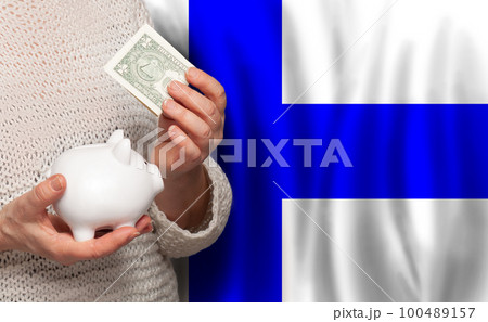Finnish woman with money bank on the background of Finland flag. Dotations, pension fund, Finnish woman with money bank on the background of Finland flag. Dotations, pension fund, 100489157