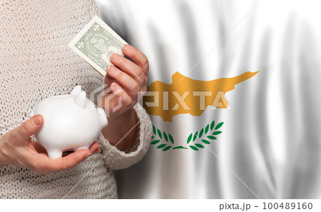 Cyprus woman with money bank on the background of Cyprus flag. Dotations, pension fund, 100489160