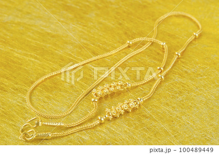 The Gold necklace on gold color background. The Gold necklace on gold color background. 100489449