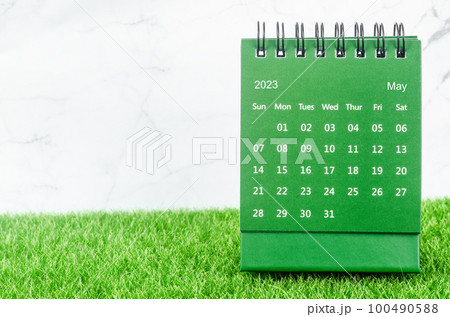 The Green May 2023 Monthly desk calendar for 2023 year on grass. 100490588