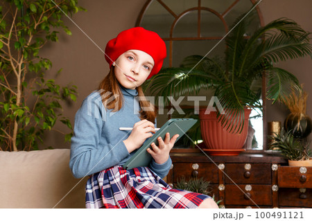 Schoolgirl Drawing on Digital Tablet Schoolgirl Drawing on Digital Tablet 100491121