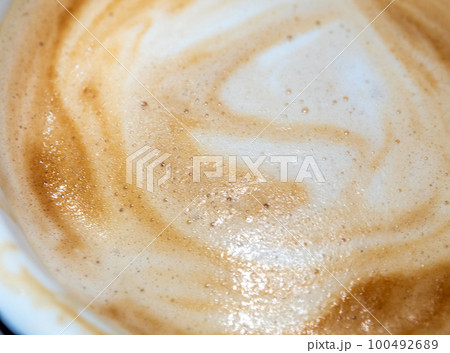 Texture surface of soft and delicate milk froth in a cup of coffee Texture surface of soft and delicate milk froth in a cup of coffee 100492689
