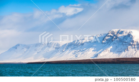 Snowy mountains under blue sky on a sunny day. Reykjavik district Snowy mountains under blue sky on a sunny day. Reykjavik district 100500580