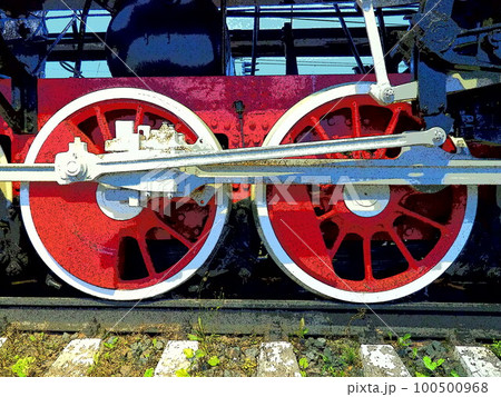 Retro vintage wheels of a locomotive or train close up. Red large heavy metal wheels with piston guiding mechanisms. Locomotive of the 19th - 20th centuries with a steam engine. Bright vivid photo 100500968