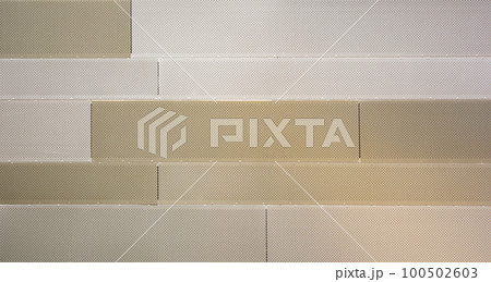 Beige metal wall made of blocks with small holes Beige metal wall made of blocks with small holes 100502603