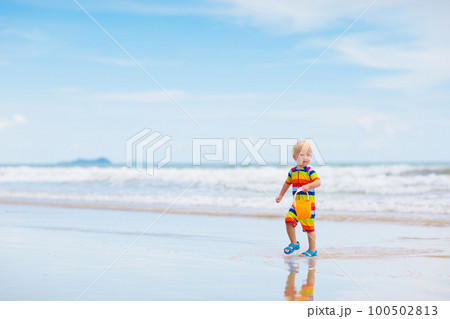 Kids play on tropical beach. Sand and water toy. Kids play on tropical beach. Sand and water toy. 100502813