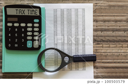 Tax Time word on calculator. Business and tax concept. Time to pay tax in year. Tax Time word on calculator. Business and tax concept. Time to pay tax in year. 100503579
