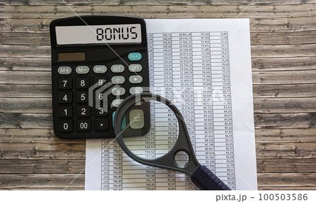 Word BONUS on the display of a calculator on financial documents. Word BONUS on the display of a calculator on financial documents. 100503586