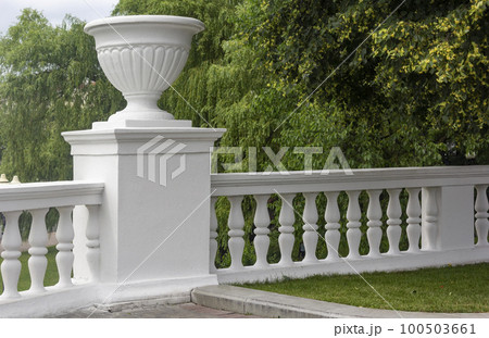 Old classic white balustrade with antique vase in the park of Minsk Old classic white balustrade with antique vase in the park of Minsk 100503661