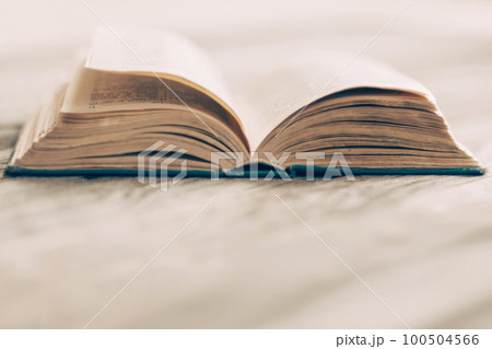 old paper book, open on wooden desk, copy space 100504566