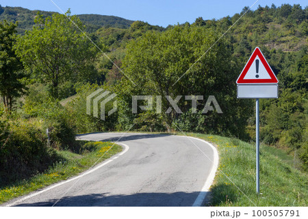 Mountain road with warning sign, Toscano Emiliano Park in Parma province, Italy Mountain road with warning sign, Toscano Emiliano Park in Parma province, Italy 100505791