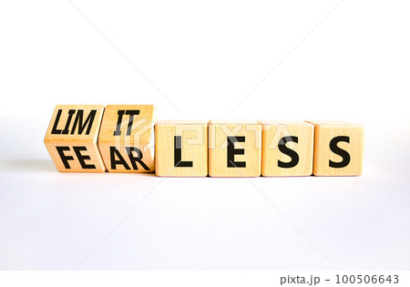 Fearless and limitless symbol. Concept word Fearless and limitless on wooden cubes. Beautiful white table white background. Business fearless and limitless concept. Copy space. 100506643