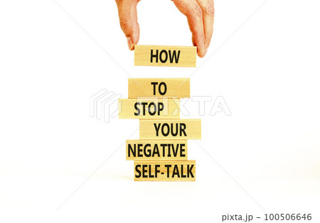 Stop negative self-talk symbol. Concept words Stop to flip your negative self-talk typed on blocks. Psychologist hand. Beautiful white background. Psychological negative self-talk concept. Copy space. Stop negative self-talk symbol. Concept words Stop to flip your negative self-talk typed on blocks. Psychologist hand. Beautiful white background. Psychological negative self-talk concept. Copy space. 100506646