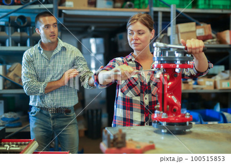 Woman fixing and assembling plumbing fixture in workshop Woman fixing and assembling plumbing fixture in workshop 100515853