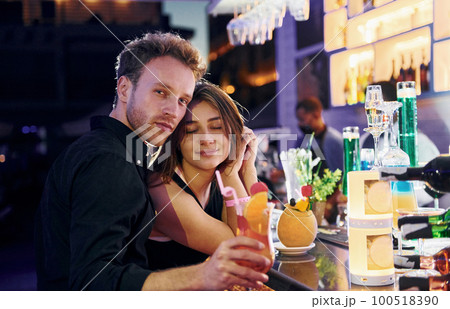 At the bar. Happy young couple is together on their vacation 100518390