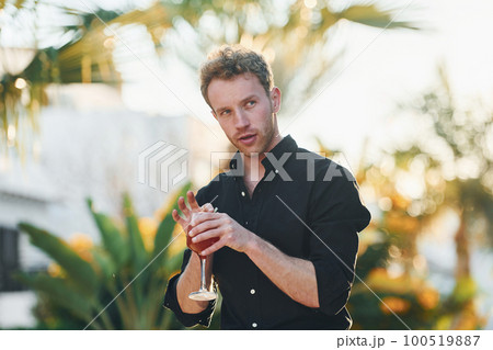 Beautiful nature. Young man is outdoors at sunny daytime. Concept of vacation 100519887