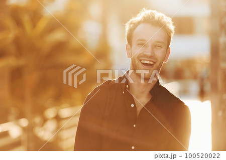 Beautiful nature. Young man is outdoors at sunny daytime. Concept of vacation Beautiful nature. Young man is outdoors at sunny daytime. Concept of vacation 100520022