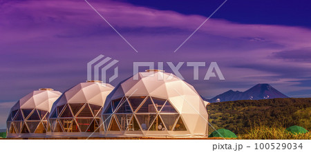 Glamping house on sunset and volcano, rural landscape, tent houses in Kamchatka peninsula 100529034