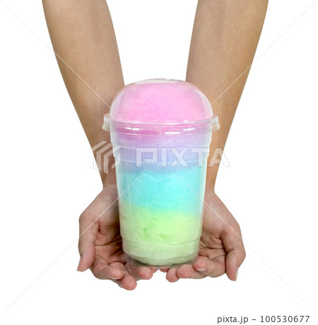 hand holding cotton candy in plastic cup isolated 100530677