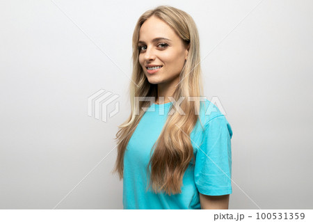european young woman in a blue tank top on a white background with free space european young woman in a blue tank top on a white background with free space 100531359