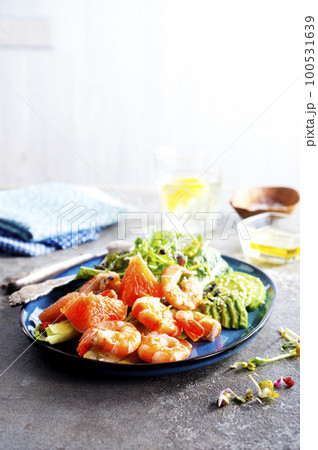 Buddha bowl with soft boiled egg, avocado, greens, grilled shrimps and sauce. Lunch bowl. 100531639
