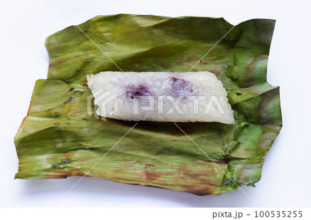 Grilled sticky rice in banana leaves with banana filling Grilled sticky rice in banana leaves with banana filling 100535255