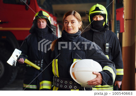 Group of firefighters in protective uniform that is on station 100540663