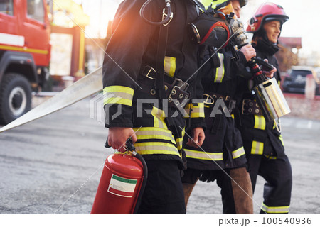 Group of firefighters in protective uniform that is on station 100540936
