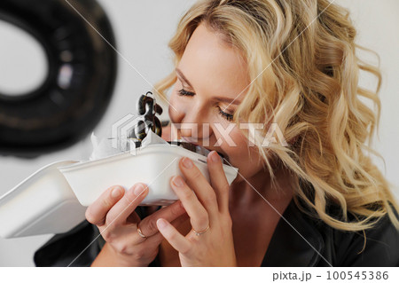 woman eats the cake with candles number thirty-five  100545386